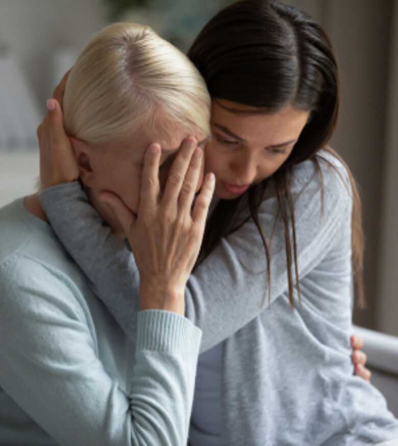 Grieving family members comfort each other, contact a wrongful death attorney in Riverside.