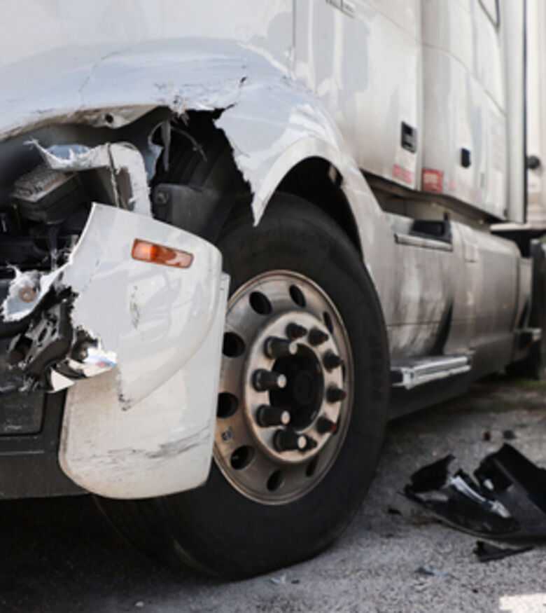 Damaged truck on road, contact a truck accident attorney in Arlington.