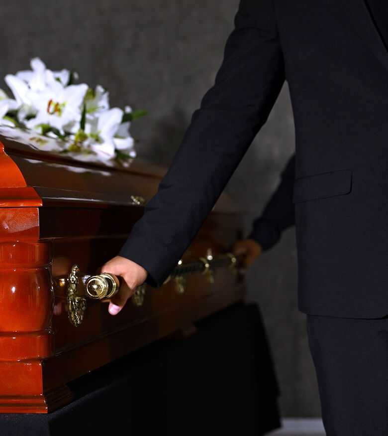 Men in suits holding a casket