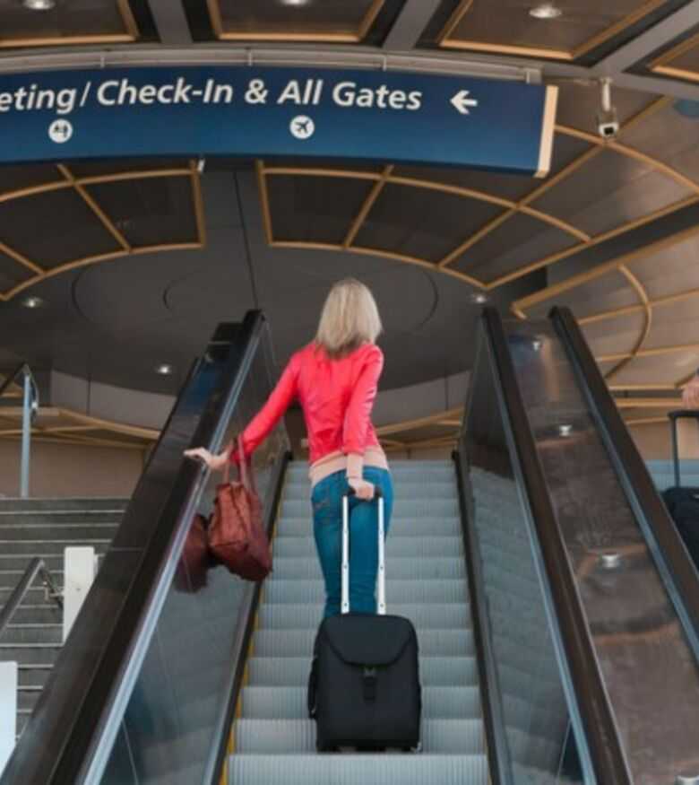 Where Can I Find the Best Airport Accident Lawyers in Big Pine Key, Florida - Woman going up on escalator at airport
