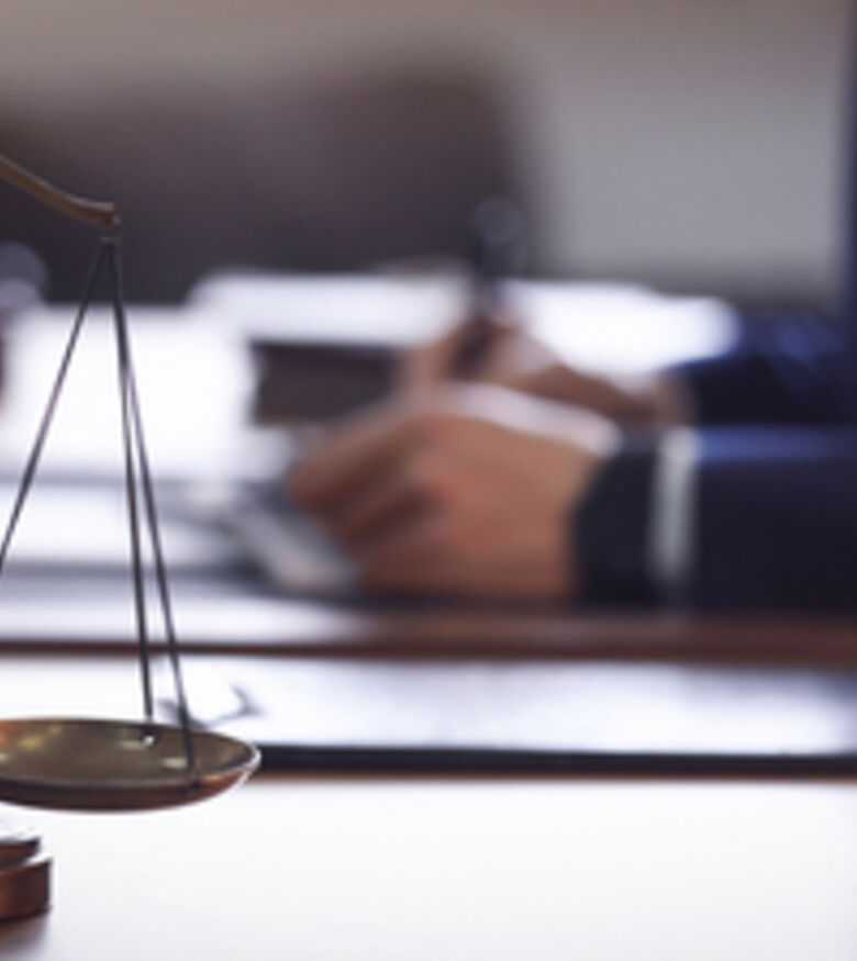Scales of justice on a lawyer's desk with a blurry background