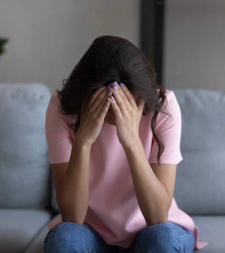 Distraught woman grieving, consider a wrongful death attorney in Raleigh.