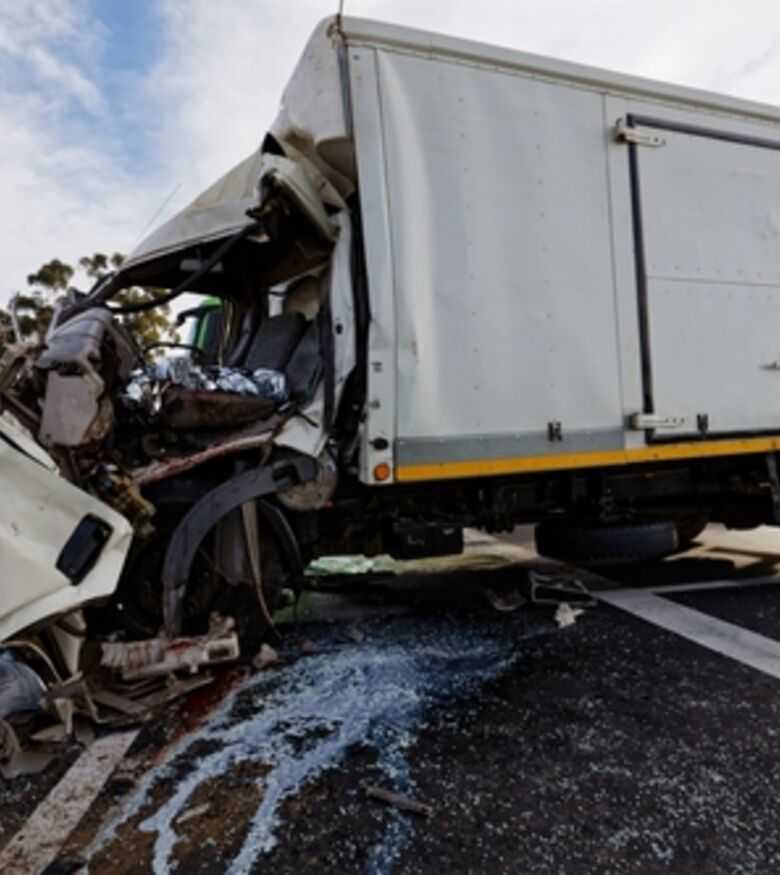 Wrecked truck on highway, contact a truck accident attorney in Baltimore.