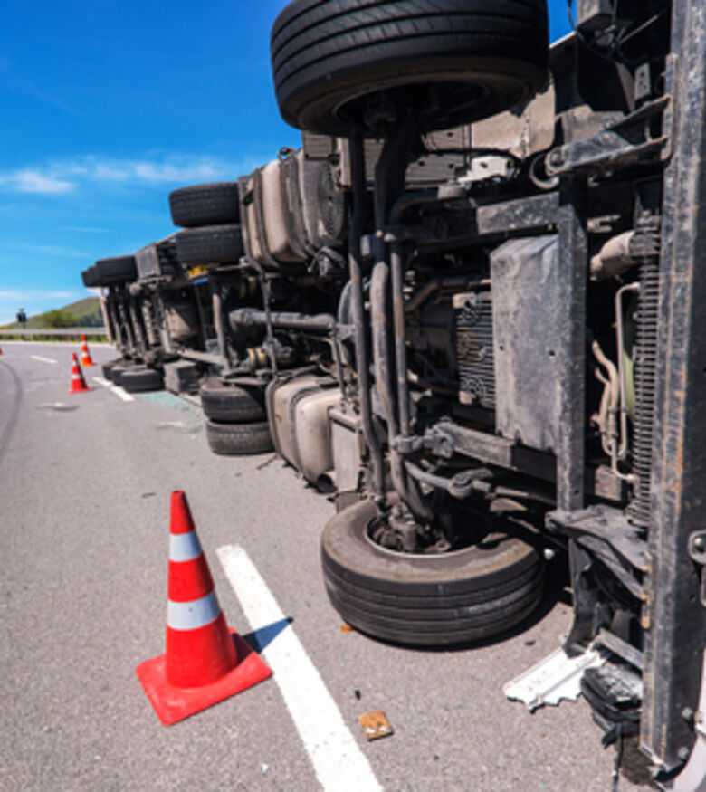 Overturned truck on road, seek a truck accident attorney in Bozeman.