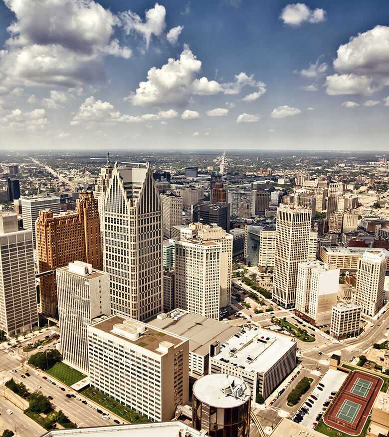 Aerial view of Detroit's bustling cityscape with skyscrapers and roads, an urban area for personal injury lawyers.