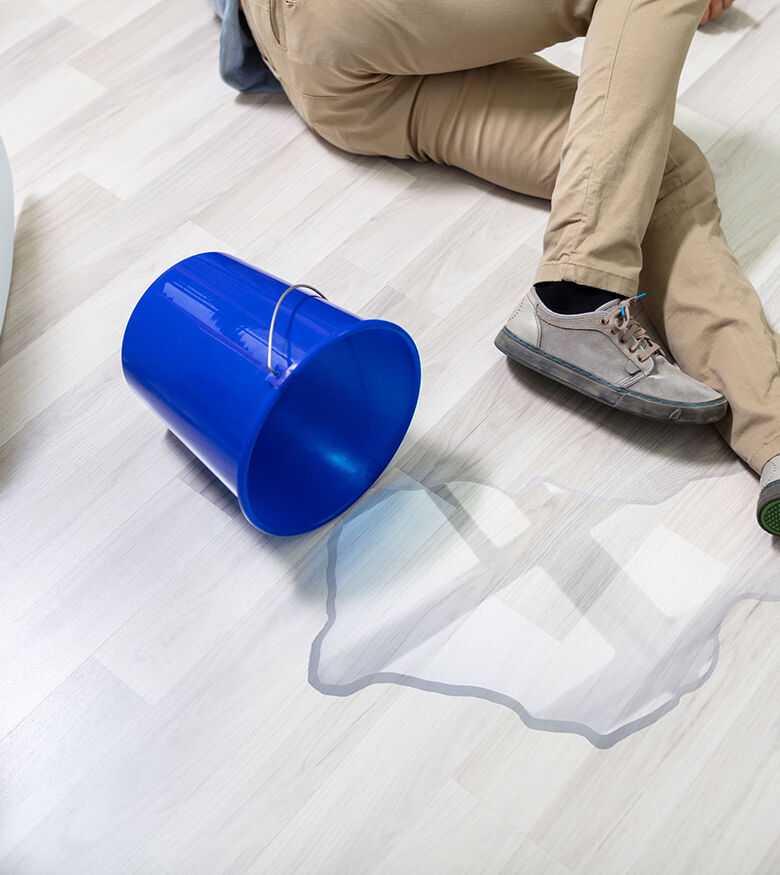Slip & Fall Lawyers in Detroit, Michigan (MI) - Man on floor with spilled bucket of water