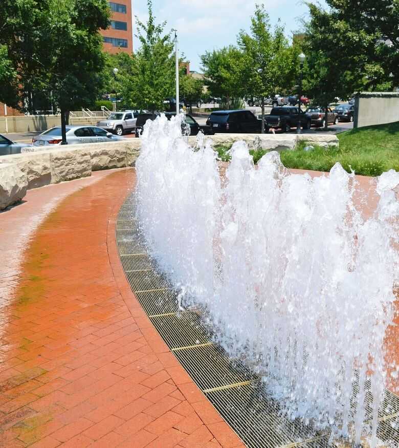 Urban fountain along a brick pathway in Evansville, a serene setting relevant for marketing Personal Injury Lawyers.