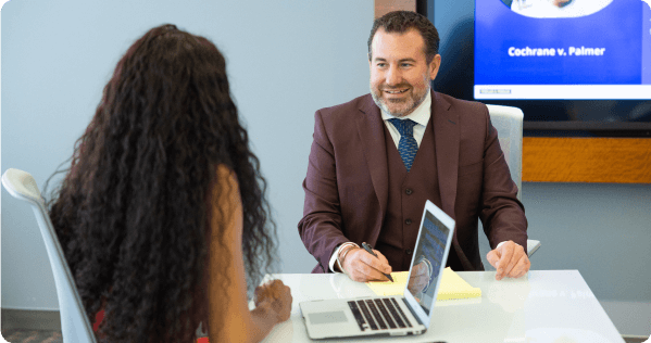 Man and woman talking in front of a computer