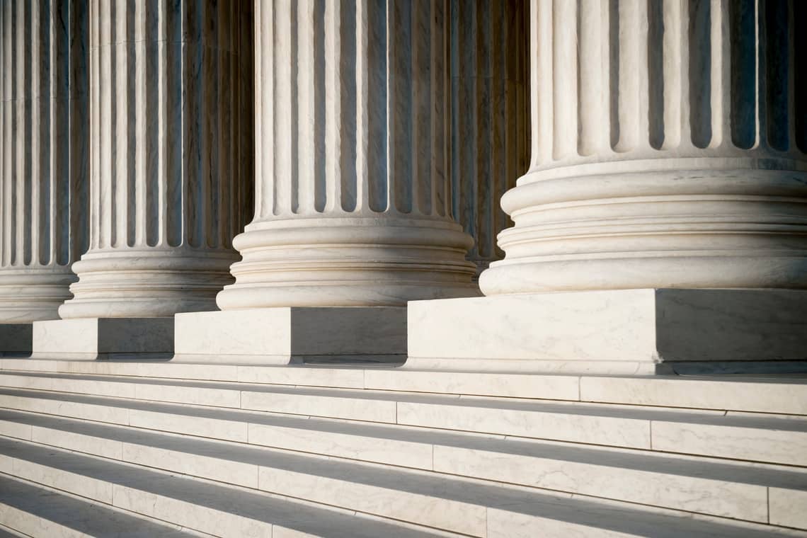 Abstract view of neoclassical fluted columns, bases and steps of the US Supreme Court building in Washington DC