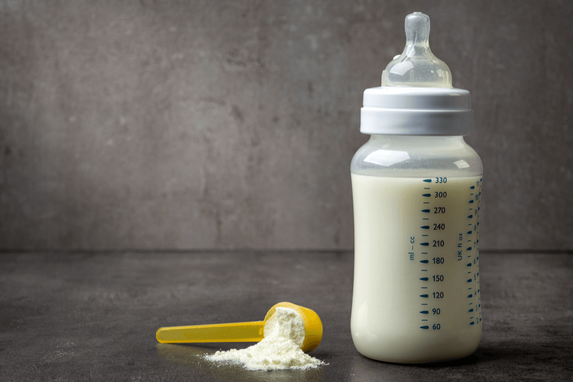 bottle of baby milk on dark grey table