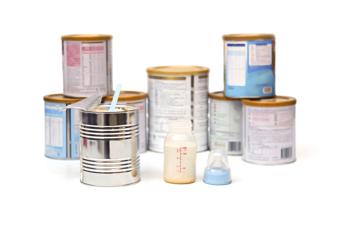 powder milk in a can with spoon with different brands of powder milk background