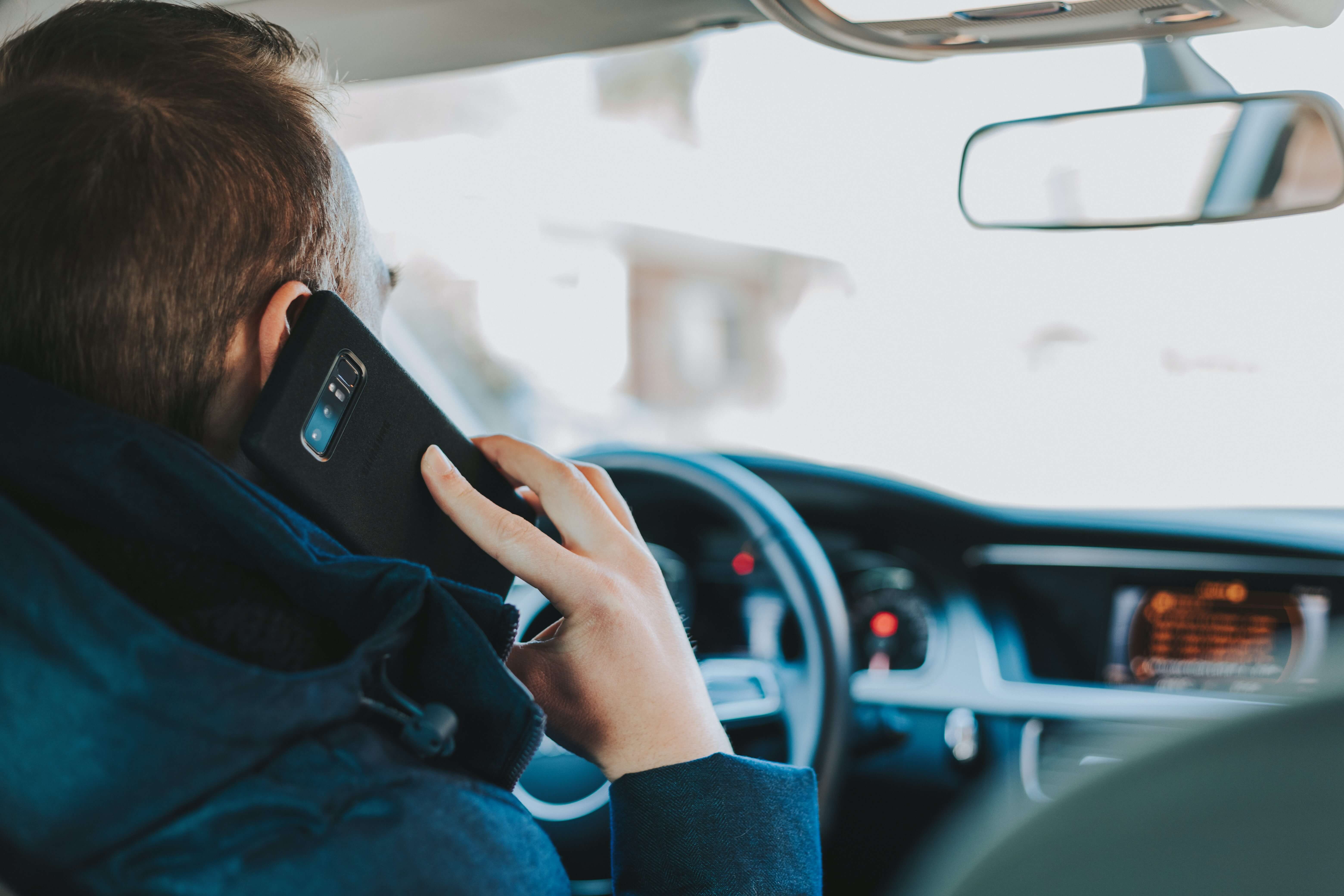 a man using his phone while driving