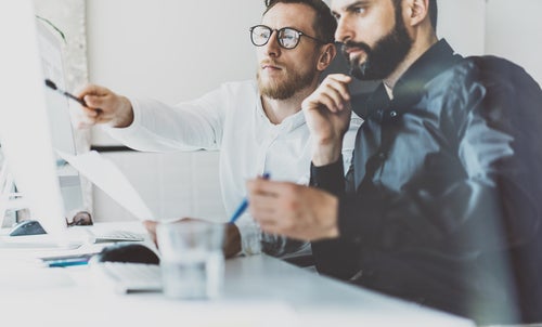 Companies Are Handing Out Manager Titles to Avoid Overtime Pay - manager and employee