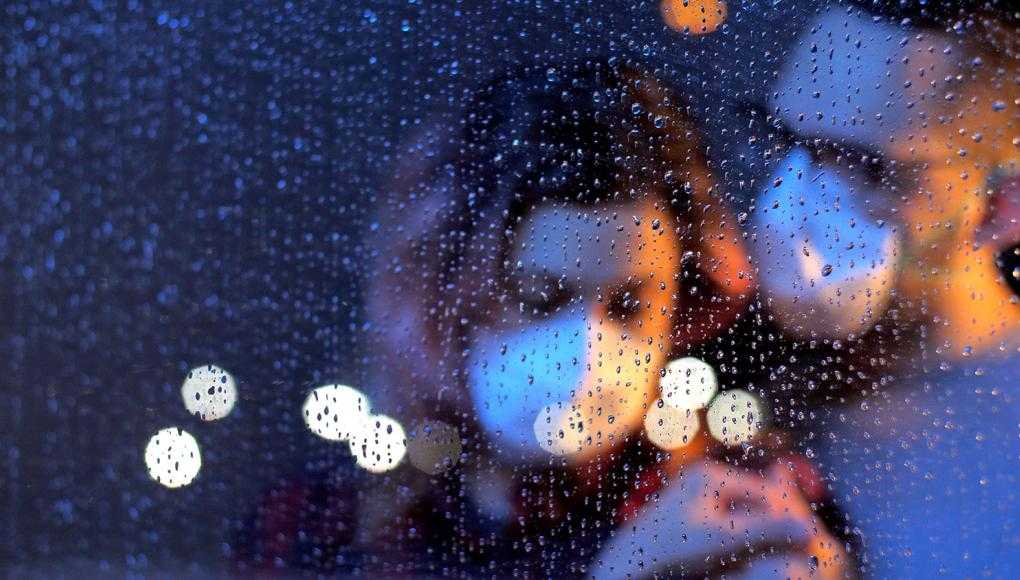 Couple with mask on in rain