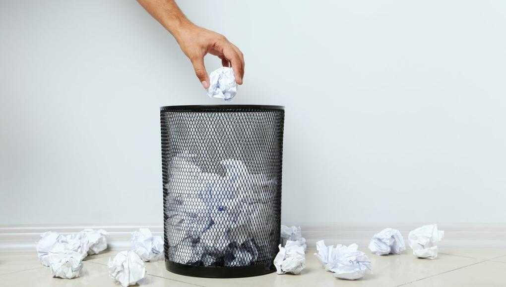 throwing paper in the trash