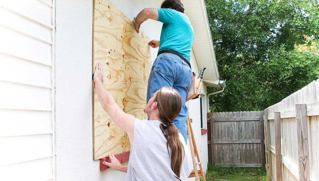 Men boarding up windows