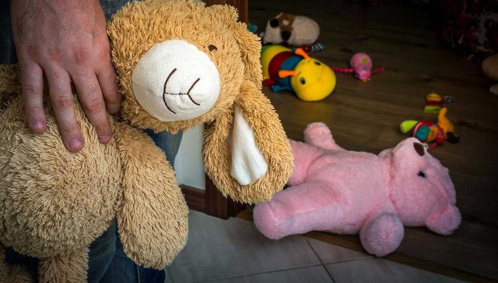 Man holding stuffed animal