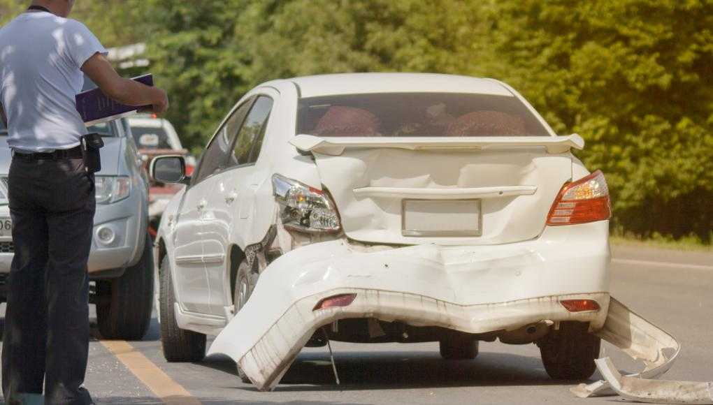 White car with a damaged bumper