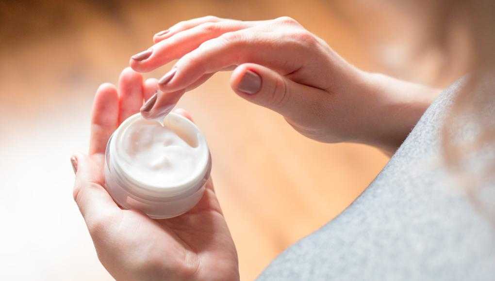 Woman holding facial cream