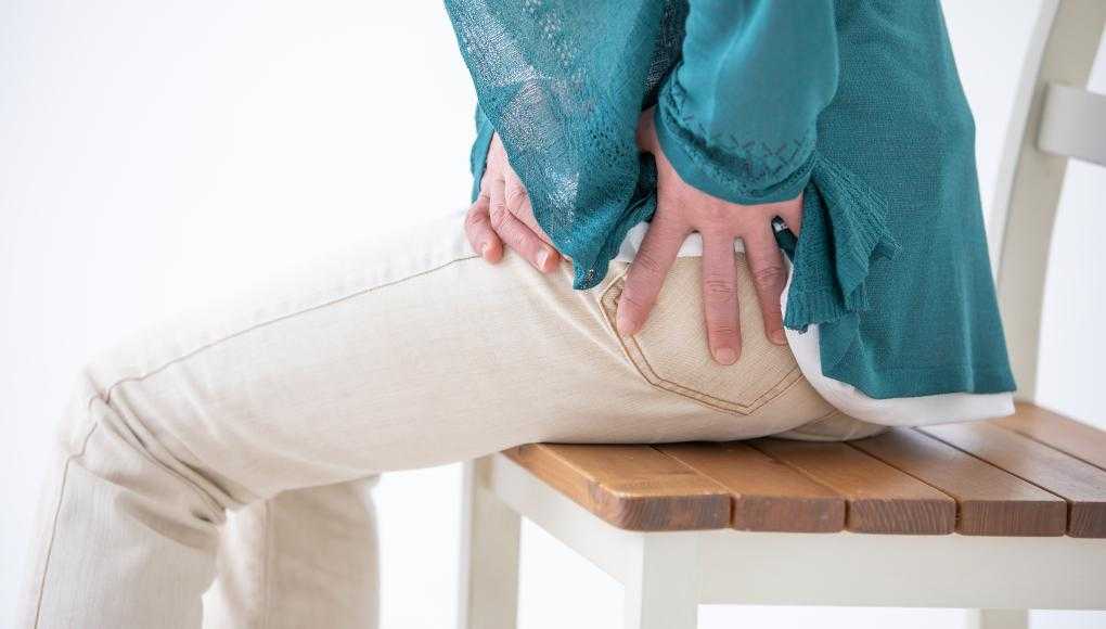 Woman holding hip in pain