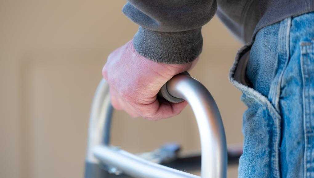Elderly man using a walker