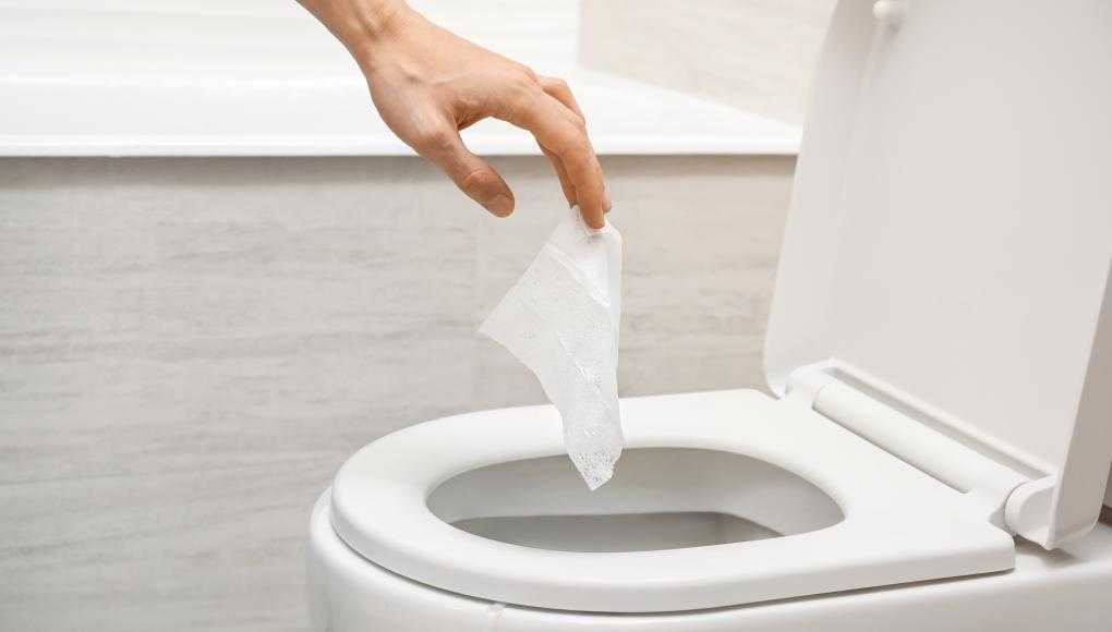 Someone throwing away toilet paper