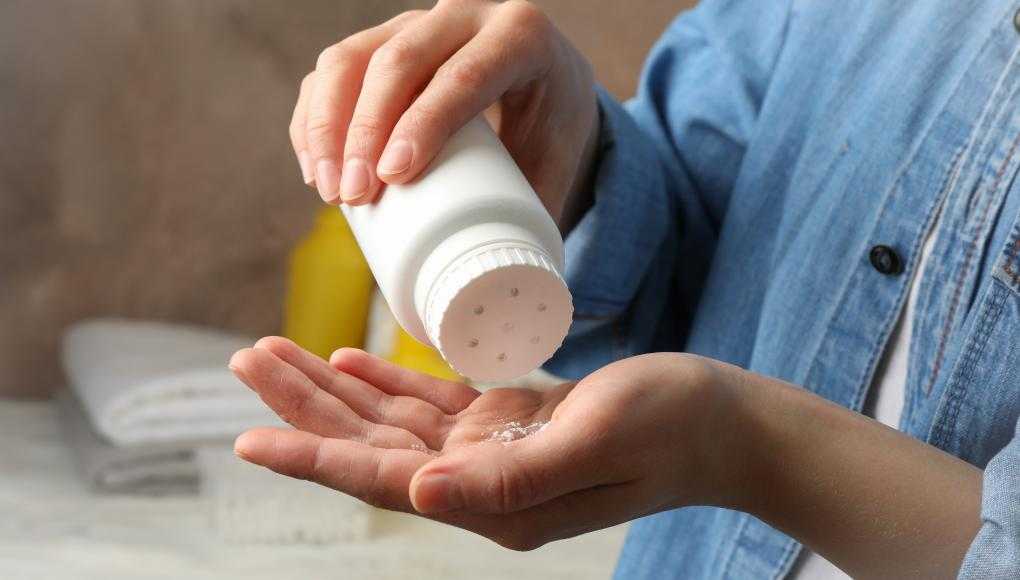 Man putting talcum powder in his hand