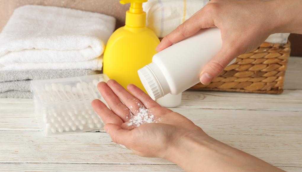 Person putting talcum powder in their hand
