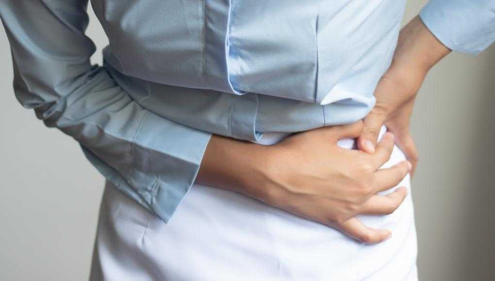 Woman holding hip in pain