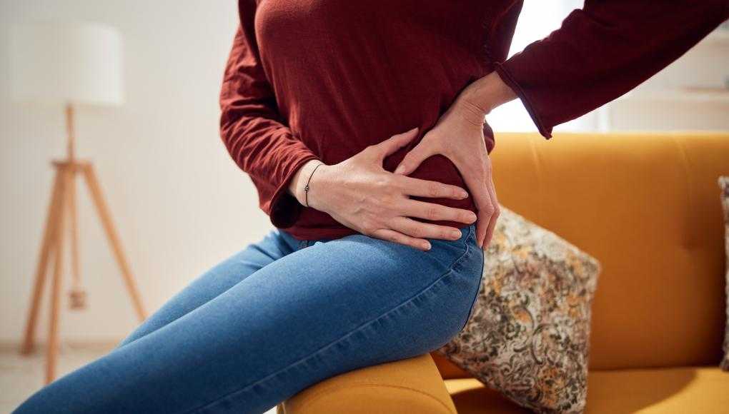 Woman holding hip in pain