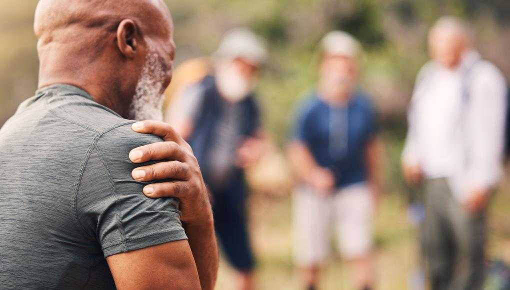 Man holding shoulder in pain