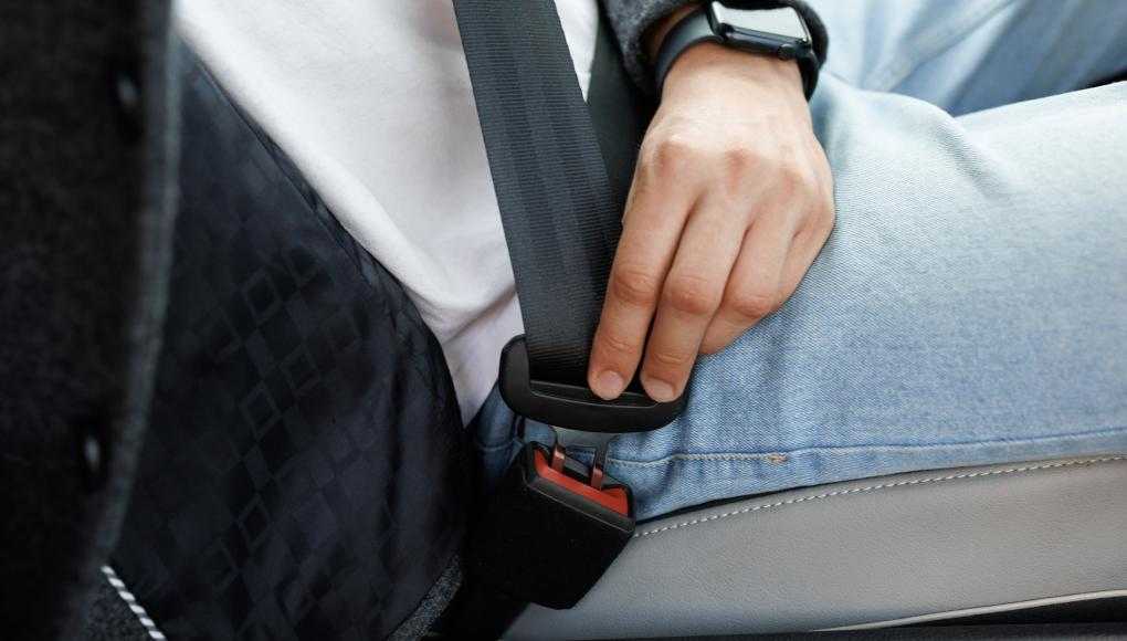 Man fastening a seat belt