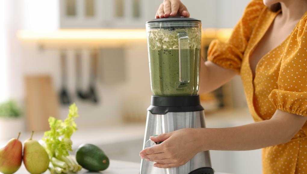 Woman using a blender
