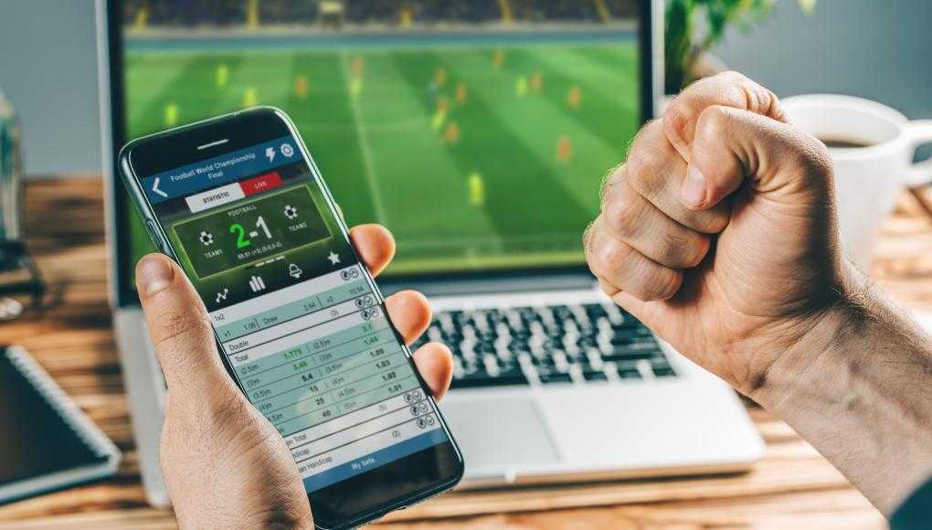 Person sports betting on cellphone 