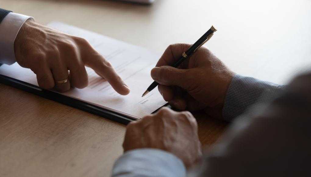 People signing documents