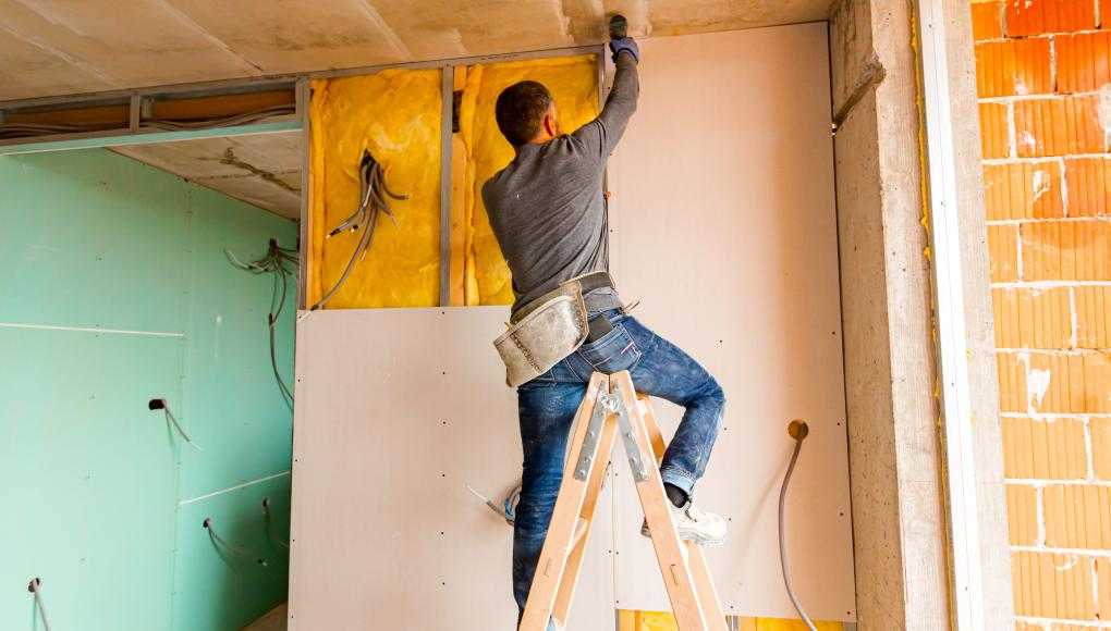 Man putting up dry wall