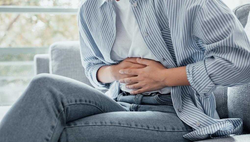 Woman holding stomach in pain