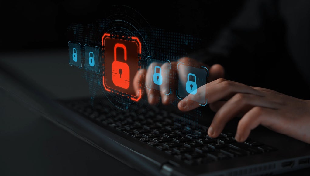 keyboard with glowing icons with a lock icon in red, signaling a data breach