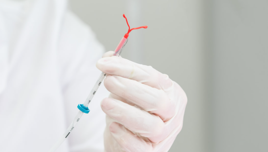 Doctor holding an IUD
