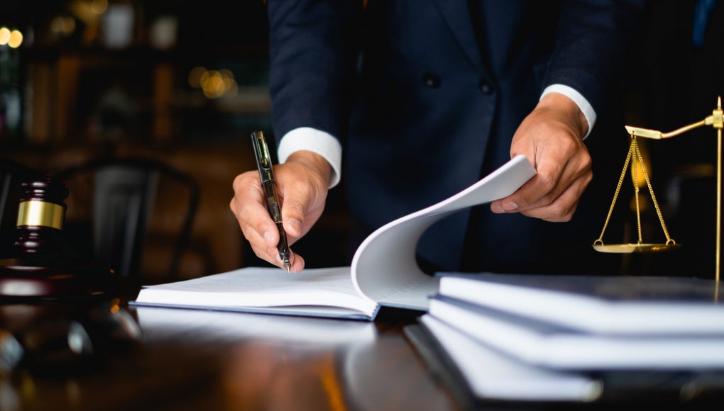 lawyer signing papers