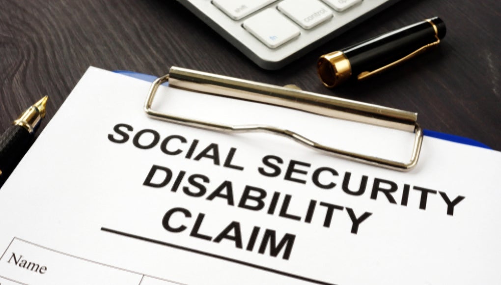 social security disability claim form on a clipboard 
