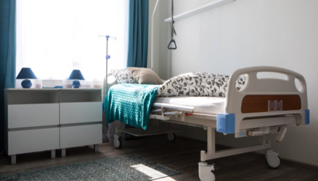 photo of a bed in a nursing home that is empty