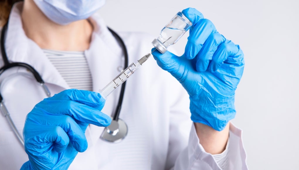Doctor using a steroid needle