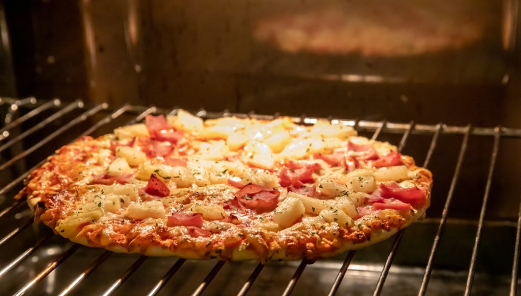 Frozen pizza in oven 