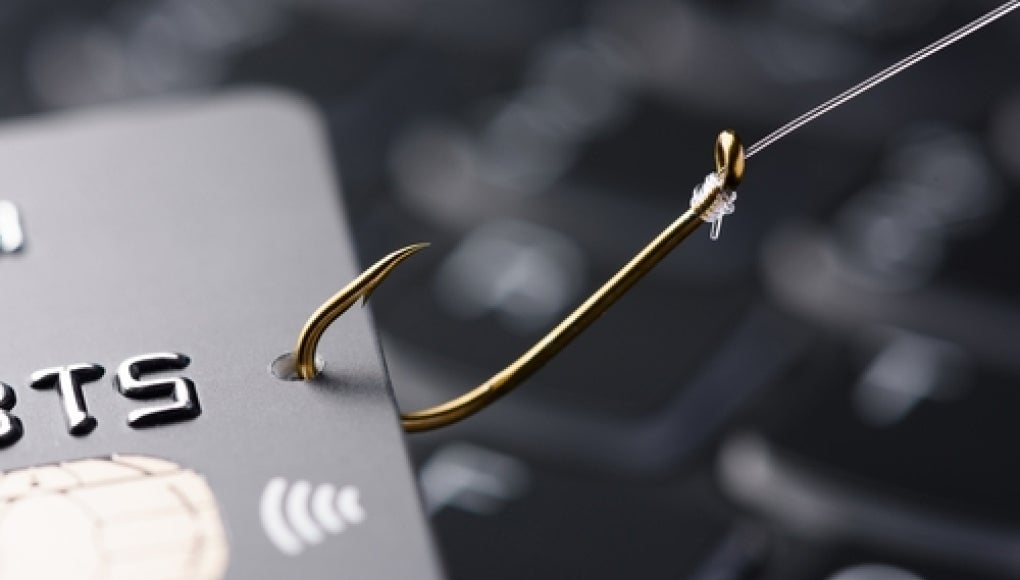 credit card on a fishing hook indicating a phishing or financial c