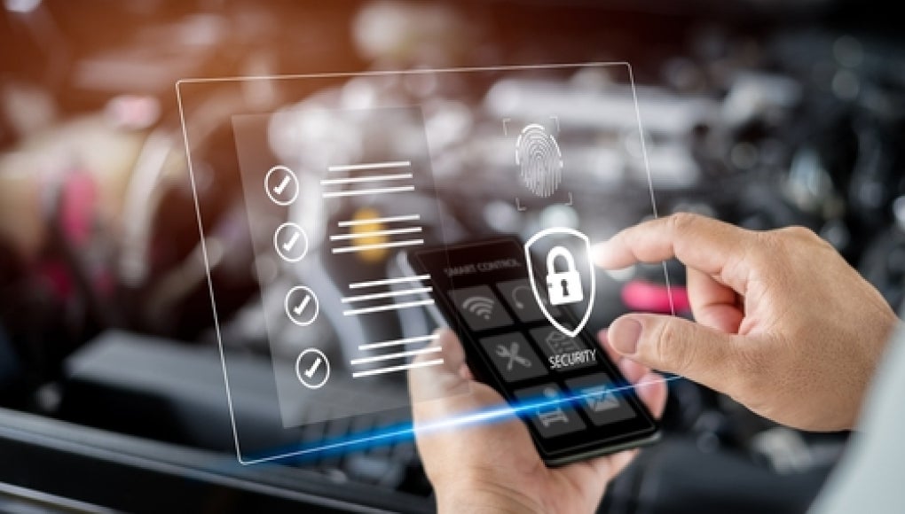 person holding device to check digital data of car 