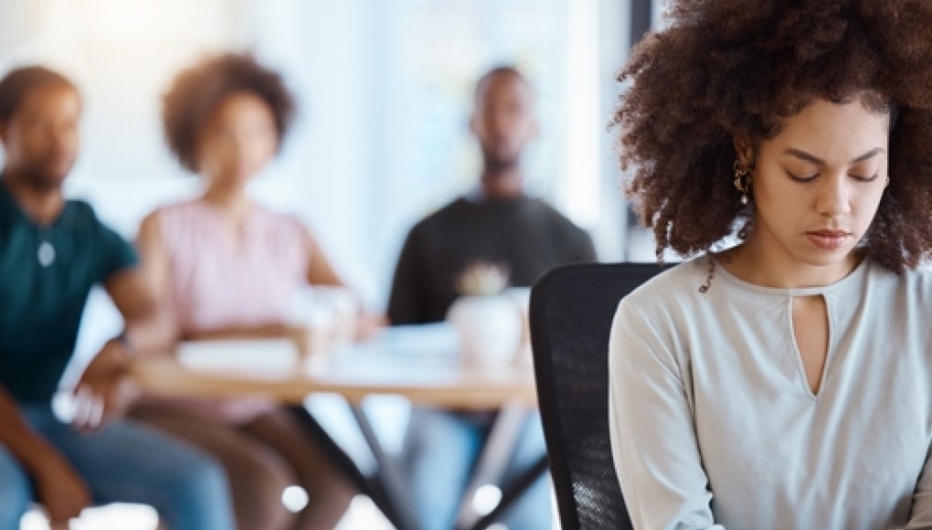 person at work being made to feel excluded by coworkers