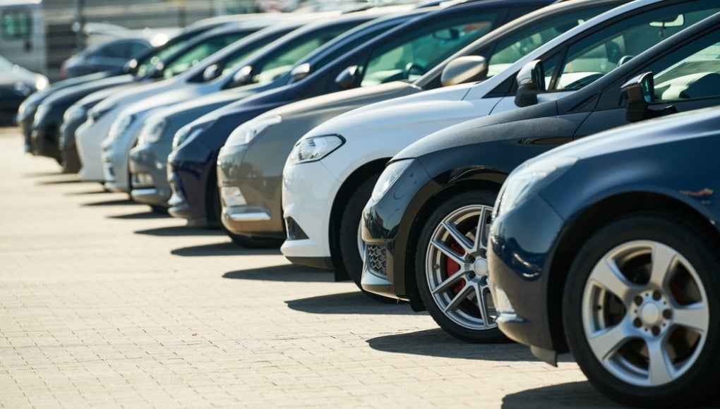 row of used cars. Rental or automobile sale services