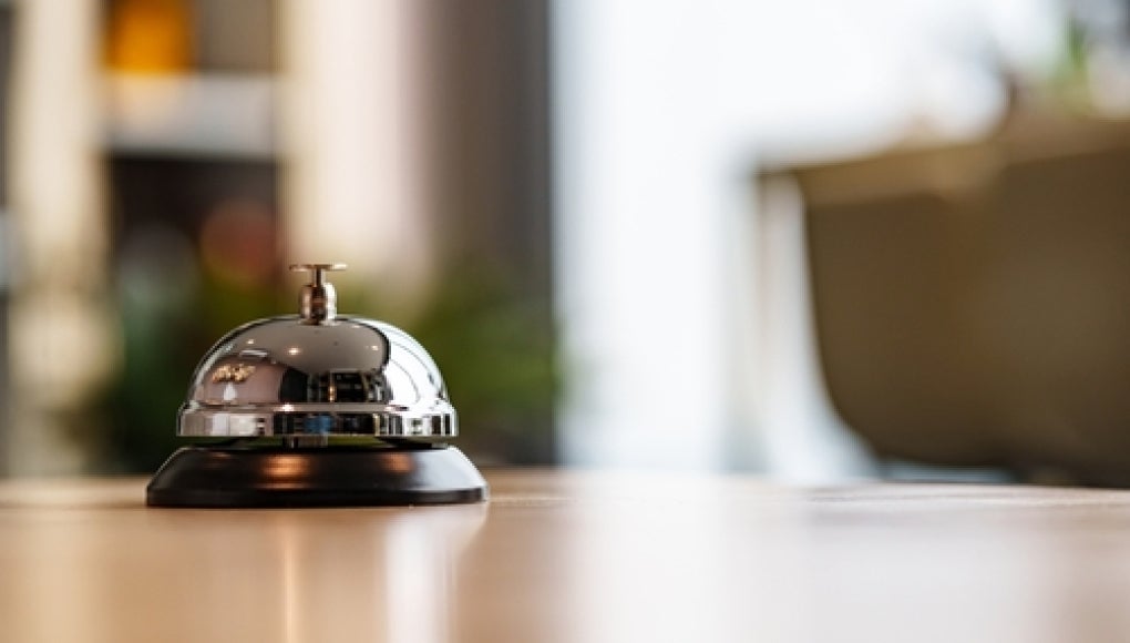bell on reception desk at hotel 