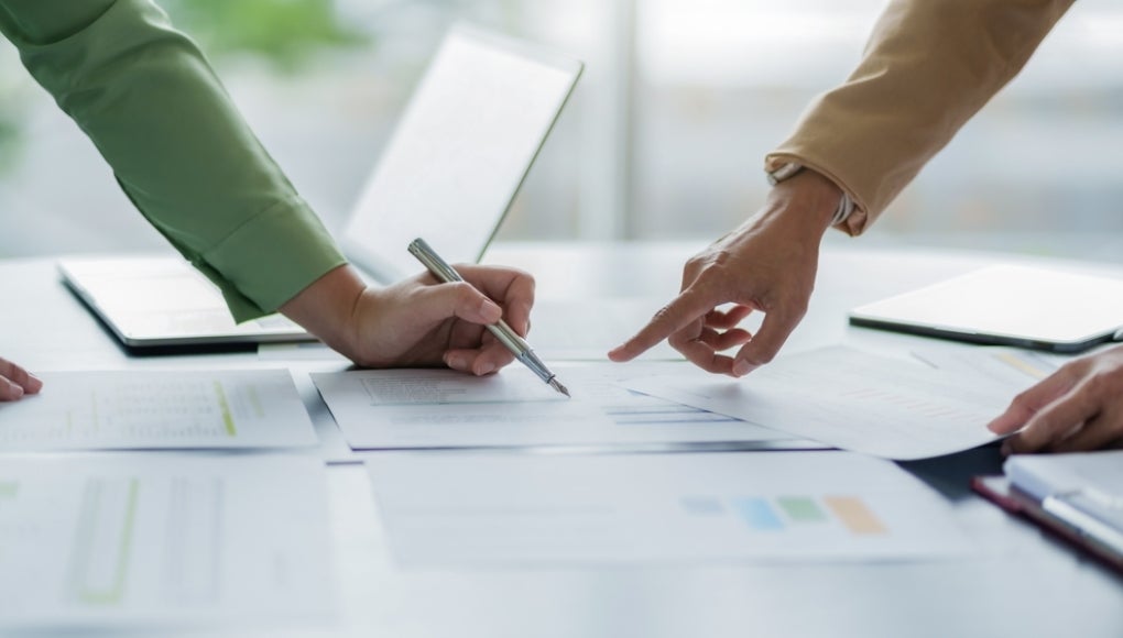 Business investor analyzing a valuation data forecast a investment project.
